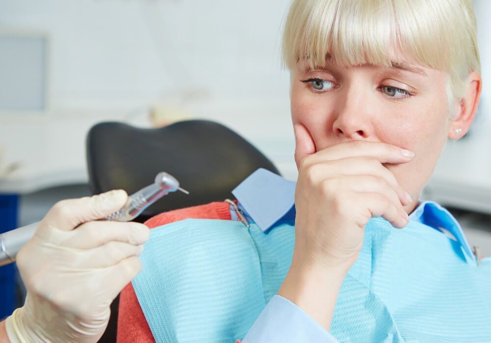 Dentist reassuring an anxious patient
